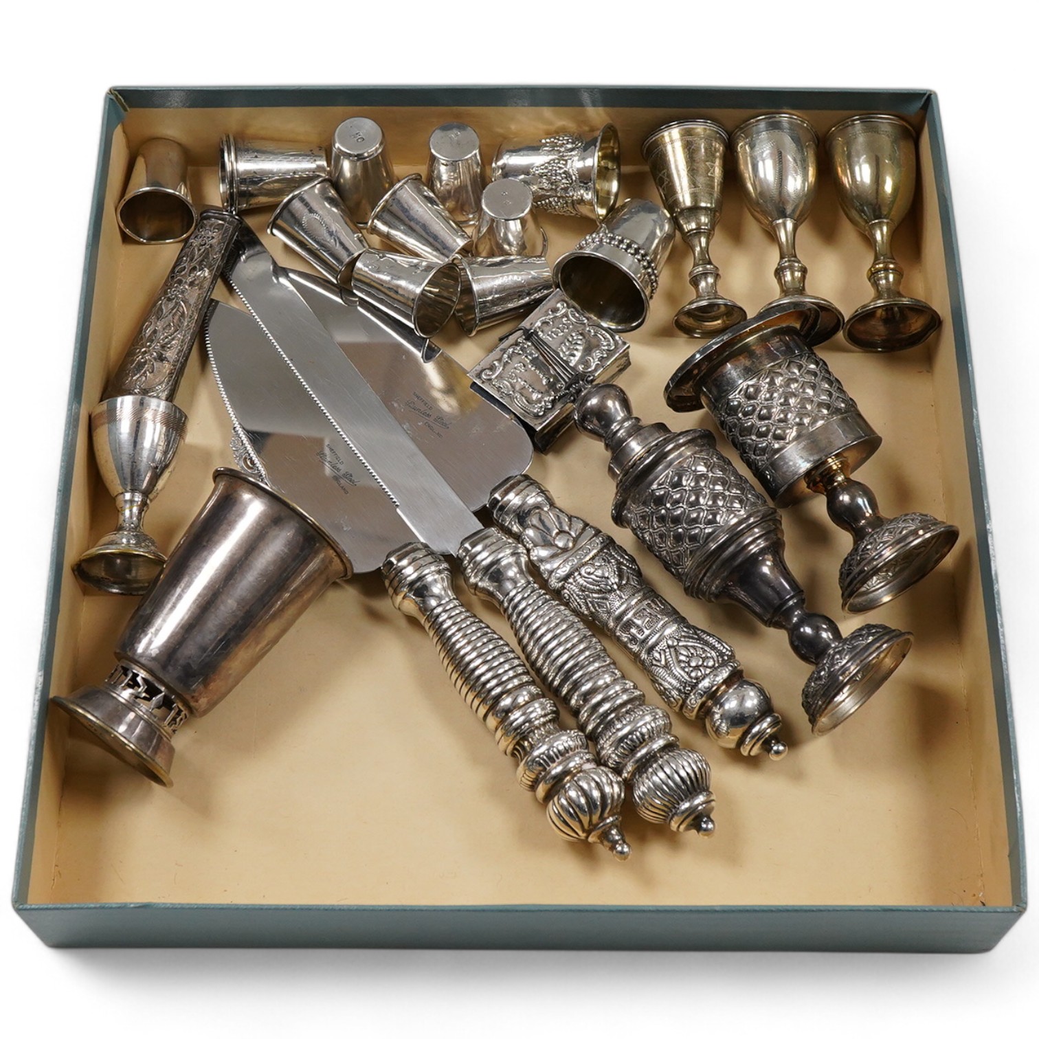 A pair of George V silver kiddush cups, maker M.S., London, 1919, 9cm, one other silver kiddush cup, two Judaic sterling tots, a set of eight Polish white metal tots, maker SJ, one other pair of Polish white metal tots,